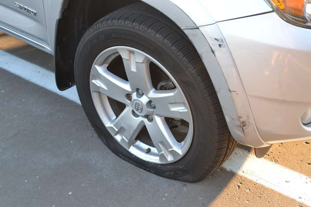A scuffed and dented fender on a parked car, car-accident claims in Oregon