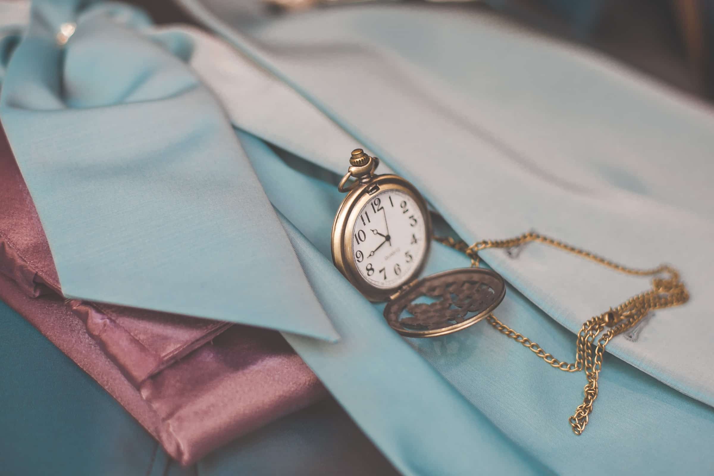 An heirloom pocket watch resting on folded silk, the careful work of settling an estate